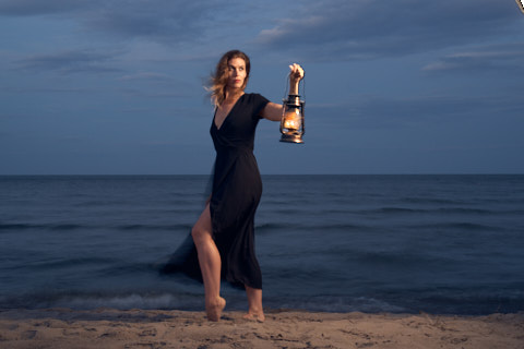 portrait of a woman with lantern on beach